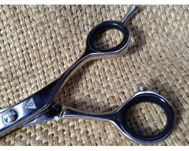 Barber Scissor with Micro Serrated edge.
